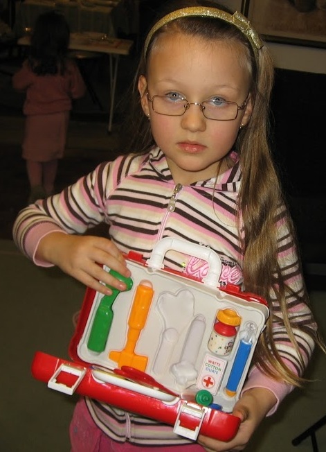 child playing with a doctor set